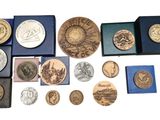 a lot of coins that are sitting in a blue box