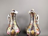 deux vases ornés de motifs floraux, posés sur une table