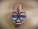 a stone with a face painted on it sitting on a table