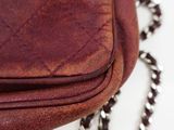 a close up of a purse with a chain around it