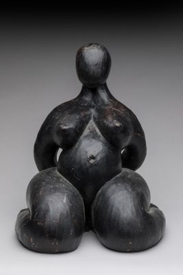 an image of a statue of a woman sitting on a ball