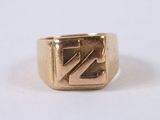 a close up of a gold ring with a z on it