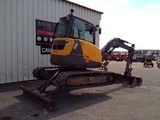 a picture of a construction vehicle parked in front of a building