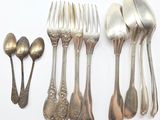 a lot of silver spoons and forks on the table