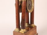 a clock that is sitting on top of a wooden stand