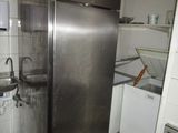 a stainless steel refrigerator in a kitchen with a sink