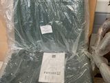 a chair that is wrapped in plastic and sitting next to a teddy bear
