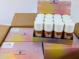 a cardboard box with a dozen of spray bottles in it
