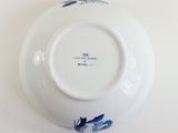 a white plate with a blue and white design on it