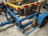 an image of a trailer with a large roll of wire on it