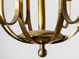 a close up of a brass chandelier hanging from a ceiling