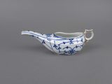 an old blue and white porcelain teapot with a handle on a gray surface