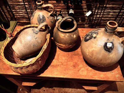 three vases sitting on a table with a basket on it