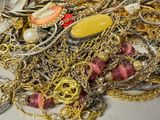 a pile of gold and silver jewelry sitting on a table