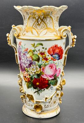 a vase with flowers painted on it sitting on a table