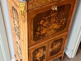 a wooden cabinet with a marble top in a room