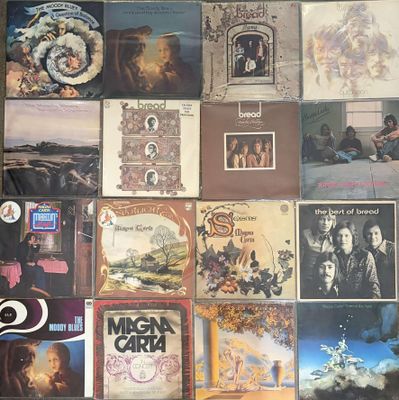 many different album covers on the wall of this room