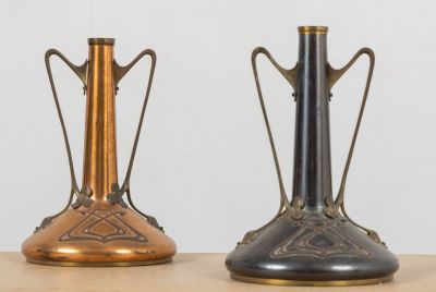 two vases that are sitting on a table