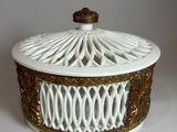 a white and gold box with a lid on a table