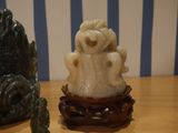 two figurines sitting on a table with a blue and white striped background