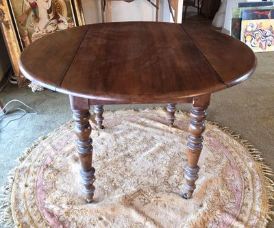 a table with a wooden top on a rug in a room