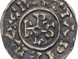 a silver coin with an image of a cross on it