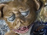 a figurine of a dog with a clock in front of it