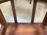 an old wooden chair with a seat made out of wood