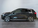 a black bmw suv parked in a room with a white wall