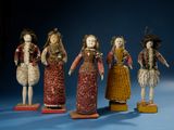 several figurines of different sizes and colors are displayed on a blue surface