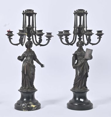 pair of antique bronze candelabs with woman holding a book and a candelab