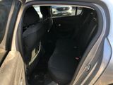 the back seat of a car with the door open and the driver ' s seat down