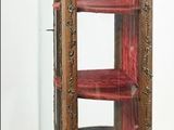 a glass display case with red shelves on it