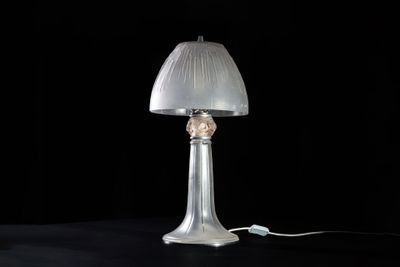 a lamp that is sitting on a table with a black background