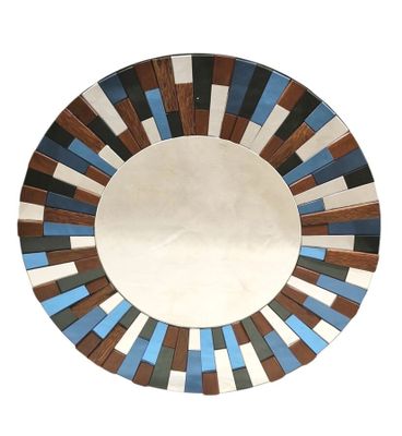 a round mirror with a multicolored design on it