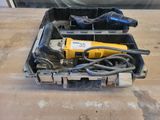 a box with a drill and a cord in it on a table