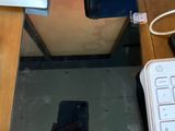 a cell phone sitting on a desk next to a keyboard and mouse