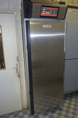 a stainless steel refrigerator in a kitchen with a checkered floor