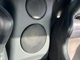 the interior of a car with two speakers and a steering wheel