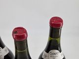 three bottles of wine sitting next to each other on a table