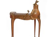 a small wooden bench with a deer on it