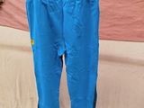 a blue pant hanging on a rail in a room