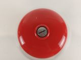 a red button on the top of a white toilet