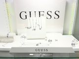 a glass display case with a bunch of jewelry on it