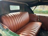 a couch in the back of a car with a window open