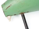 a close up of a green lamp on a white surface