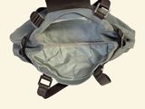 a bag with a handle hanging from it ' s side