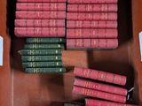 many books in a brown box on a table