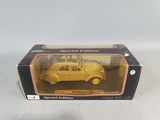 an old yellow toy car in a box on a white surface