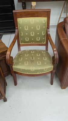 une chaise en bois avec une assise rembourrée verte dans une pièce